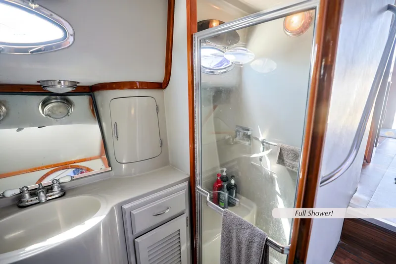 Slide: The Image of Bathroom interior of 1993 Mediterranean 38 Convertible yacht with full shower and sink. - 13