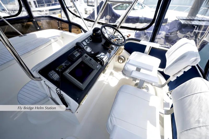 Slide: The Image of Flybridge helm station of 1993 Mediterranean 38 Convertible yacht, featuring modern controls and seating. - 16