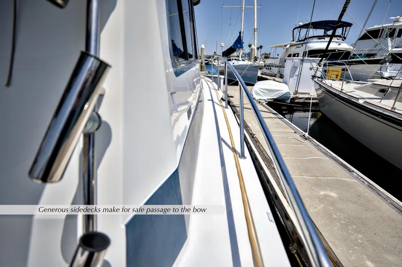 Slide: The Image of 1993 Mediterranean 38 Convertible yacht with spacious side decks in a marina. - 22