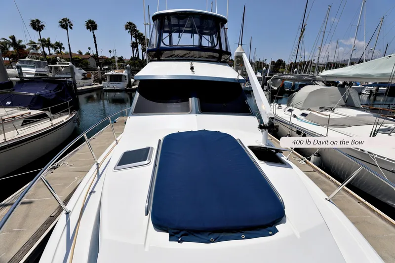 Slide: The Image of 1993 Mediterranean 38 Convertible yacht with 400 lb davit on bow, docked in marina. - 24