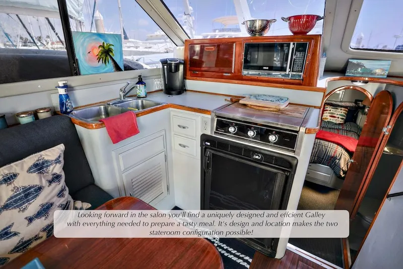 Slide: The Image of Interior of 1993 Mediterranean 38 Convertible yacht with compact galley and cozy stateroom. - 8