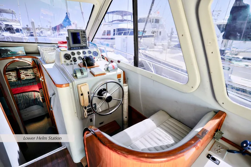 Slide: The Image of Lower helm station of 1993 Mediterranean 38 Convertible yacht, featuring steering wheel and controls. - 9
