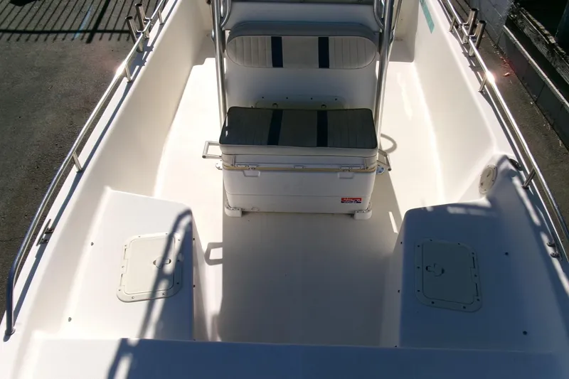 Slide: The Image of 2001 Sea Fox 215 Bay Fisher boat interior with seating and storage compartments. - 10