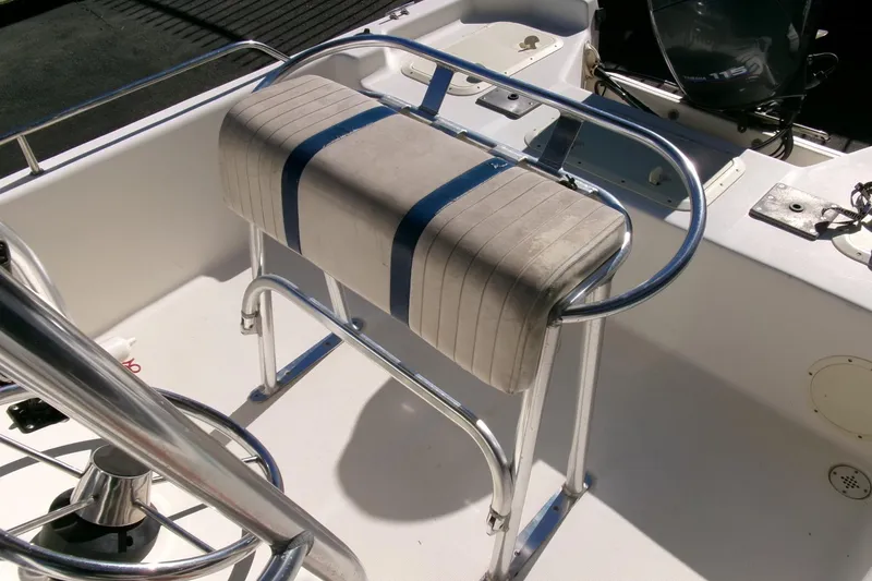 Slide: The Image of 2001 Sea Fox 215 Bay Fisher boat interior with cushioned seat and metal railing. - 15