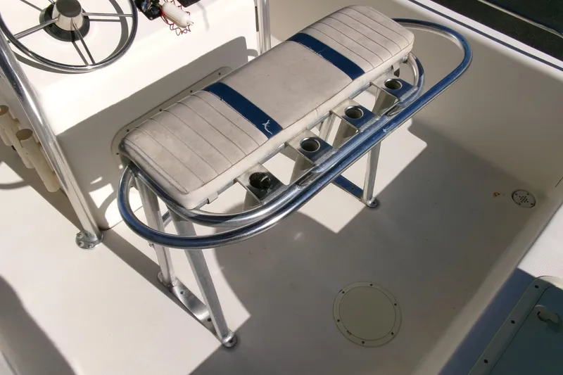 Slide: The Image of 2001 Sea Fox 215 Bay Fisher boat interior with cushioned seating and rod holders. - 16