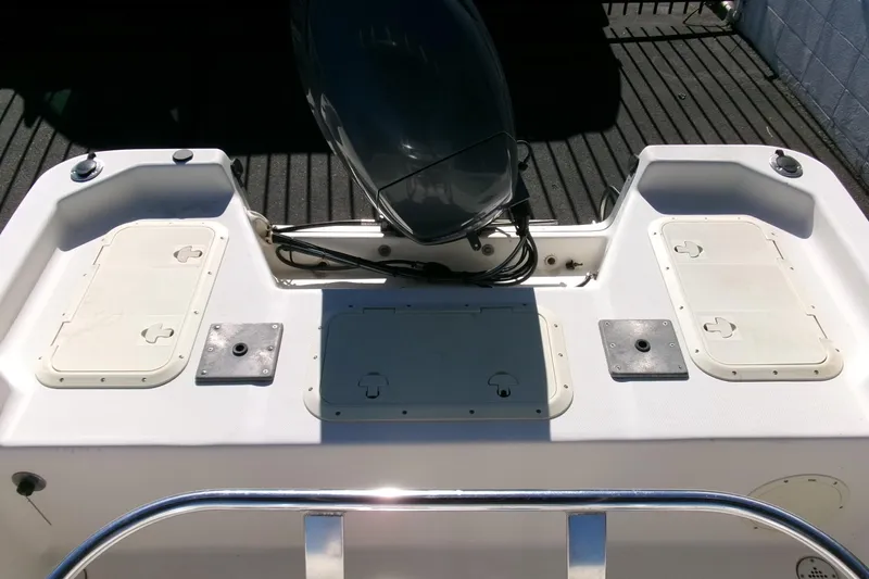 Slide: The Image of 2001 Sea Fox 215 Bay Fisher boat deck with storage compartments and motor. - 17