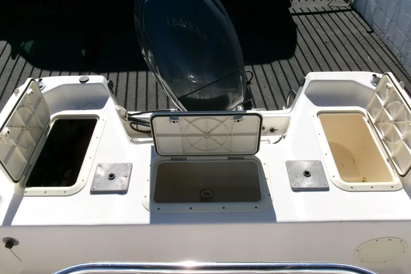 Slide: The Image of 2001 Sea Fox 215 Bay Fisher boat with open storage compartments on deck. - 18
