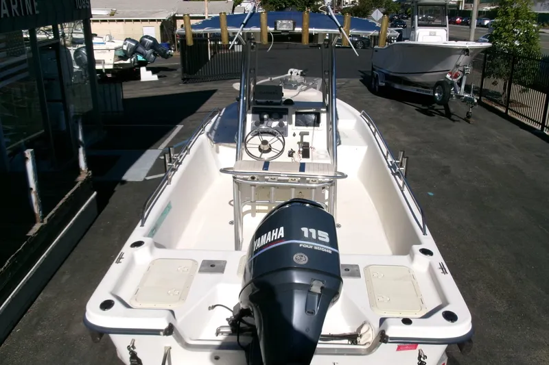 Slide: The Image of 2001 Sea Fox 215 Bay Fisher boat with Yamaha 115 engine, docked outdoors. - 21