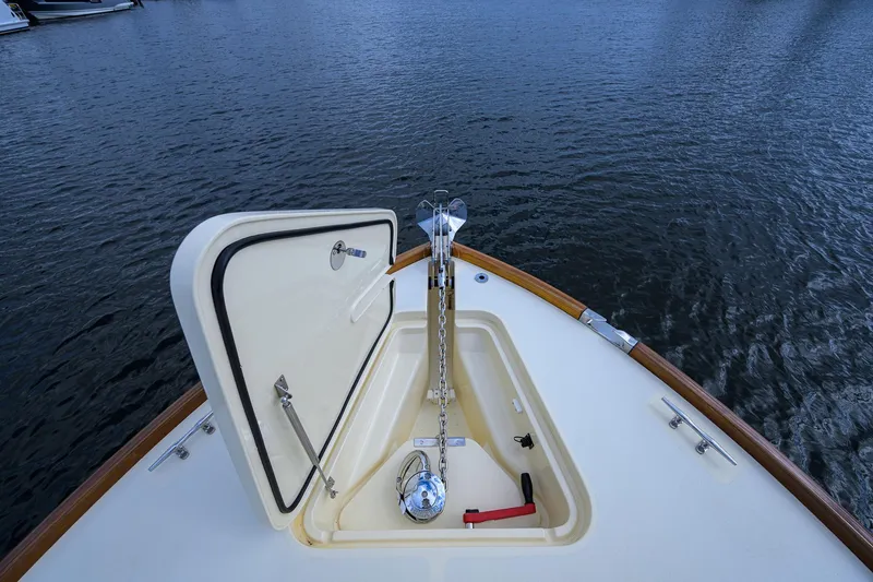 Slide: The Image of 2017 Hinckley Picnic Boat 37 MKIII anchor locker open on calm water. - 12