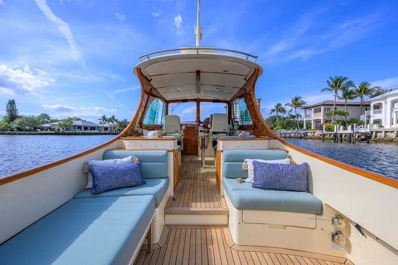 Slide: The Image of 2017 Hinckley Picnic Boat 37 MKIII with elegant seating, docked by waterfront homes. - 15