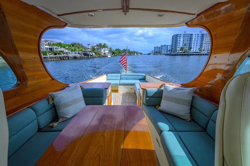 Slide: The Image of 2017 Hinckley Picnic Boat 37 MKIII interior with elegant seating and waterfront view. - 16