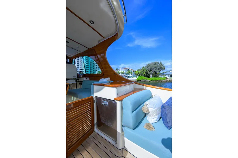 Slide: The Image of 2017 Hinckley Picnic Boat 37 MKIII interior with blue seating and waterfront view. - 19