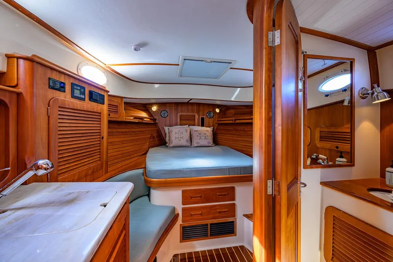 Slide: The Image of Luxurious 2017 Hinckley Picnic Boat 37 MKIII cabin with elegant wood interior and cozy bed. - 25
