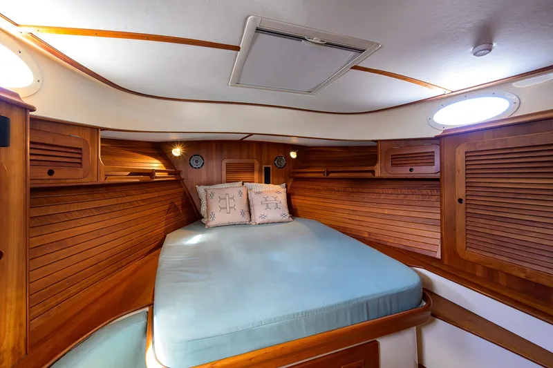 Slide: The Image of Luxurious cabin interior of 2017 Hinckley Picnic Boat 37 MKIII with wooden finish and cozy bed. - 26
