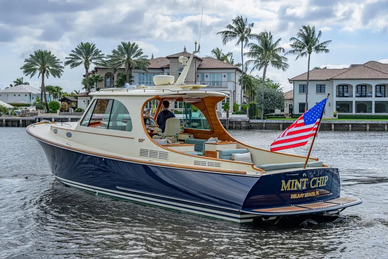Slide: The Image of 2017 Hinckley Picnic Boat 37 MKIII, "Mint Chip," cruising near waterfront homes. - 3