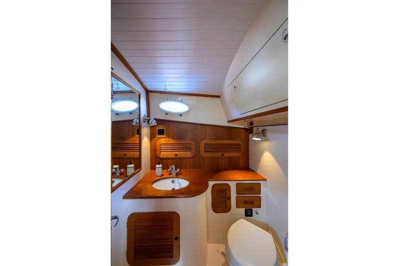 Slide: The Image of Luxurious 2017 Hinckley Picnic Boat 37 MKIII bathroom with elegant wood finishes. - 30