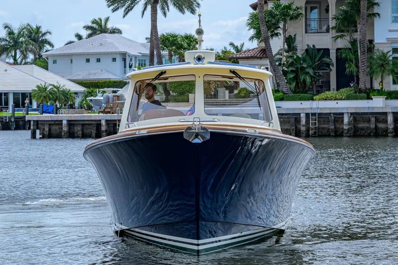 Slide: The Image of 2017 Hinckley Picnic Boat 37 MKIII cruising near waterfront homes. - 8