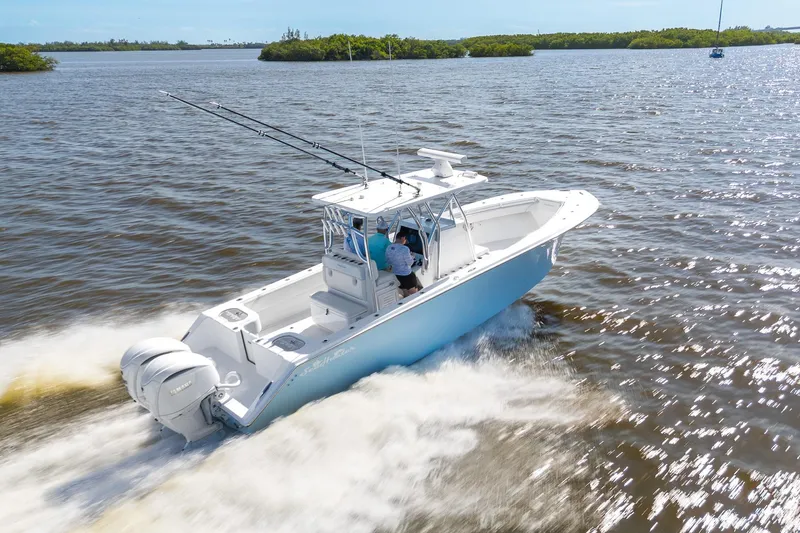 The Image of 2025 SeaHunter 31 Tournament boat cruising on open water, showcasing sleek design and powerful engines. - 0