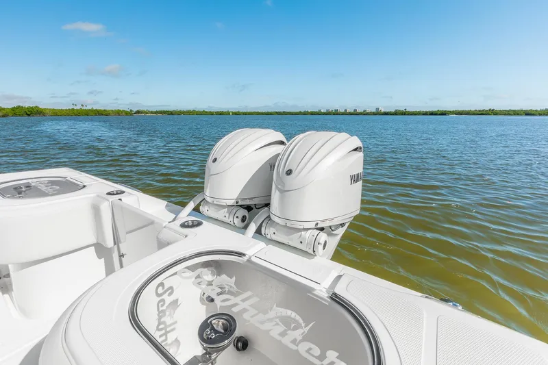 Slide: The Image of 2025 SeaHunter 31 Tournament boat with dual Yamaha engines on a sunny day. - 11