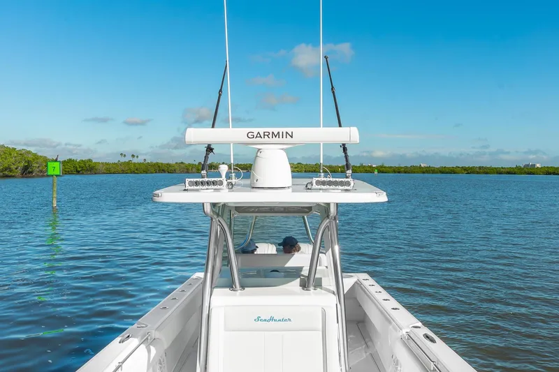 Slide: The Image of 2025 SeaHunter 31 Tournament boat on calm water, featuring Garmin equipment. - 16