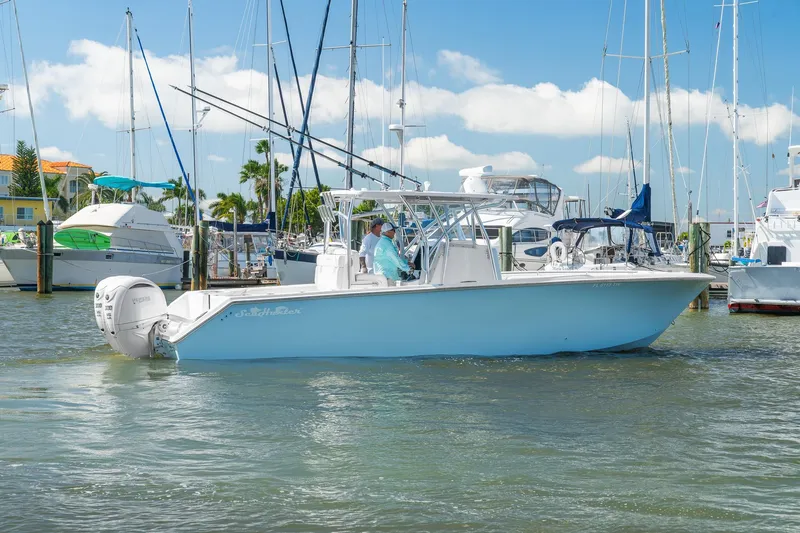 Slide: The Image of 2025 SeaHunter 31 Tournament boat docked in a sunny marina. - 2