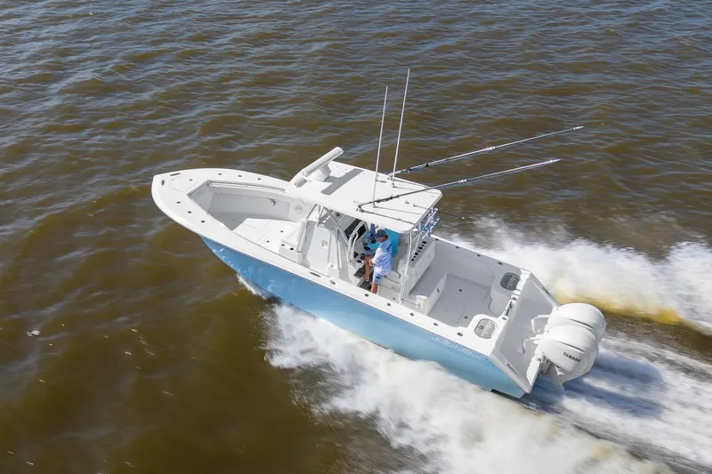 Slide: The Image of 2025 SeaHunter 31 Tournament boat cruising on open water, side view. - 3