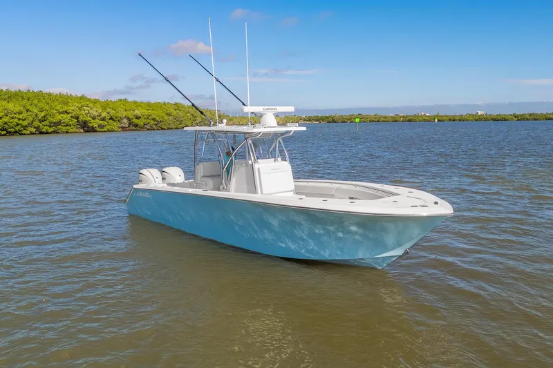 Slide: The Image of 2025 SeaHunter 31 Tournament boat on calm water under clear blue sky. - 5