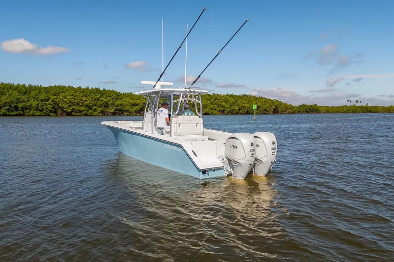 Slide: The Image of 2025 SeaHunter 31 Tournament boat with dual Yamaha engines on calm water. - 8