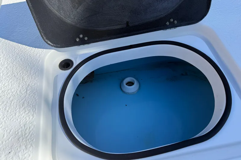 Slide: The Image of 2024 SCB R24 boat on trailer, featuring Suzuki engine, parked outdoors. - 14