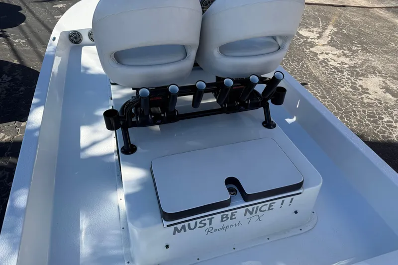 Slide: The Image of 2024 SCB R24 boat with open storage compartments and motor, showcasing deck features. - 18