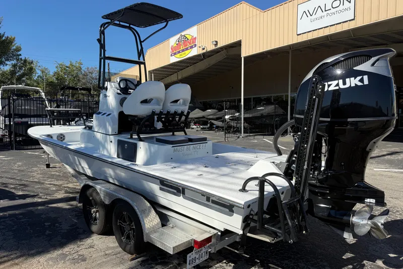 Slide: The Image of 2024 SCB R24 boat docked with protective covers on seats and console. - 2