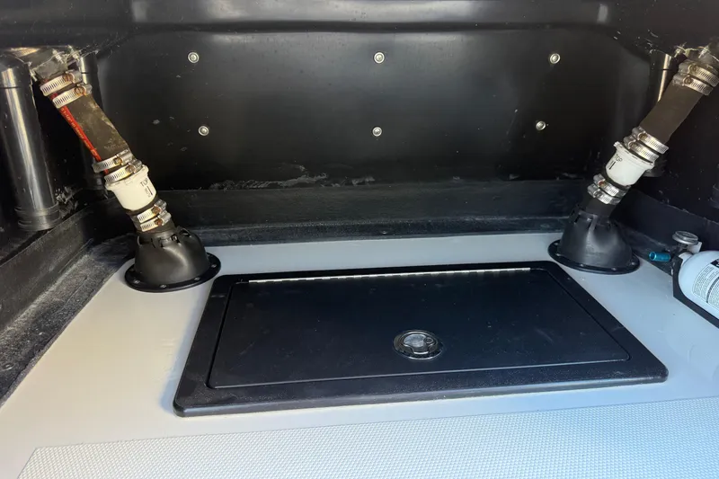 Slide: The Image of 2024 SCB R24 boat at South Austin Marine dealership under clear blue sky. - 25