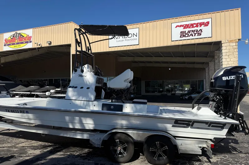 Slide: The Image of Man holding fish on SCB R24 boat, 2024 model, in sunny waters. - 3
