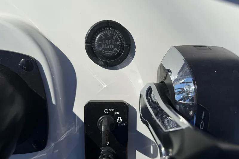 Slide: The Image of 2024 SCB R24 boat dashboard with open compartment, showing wiring and red coiled cable. - 30