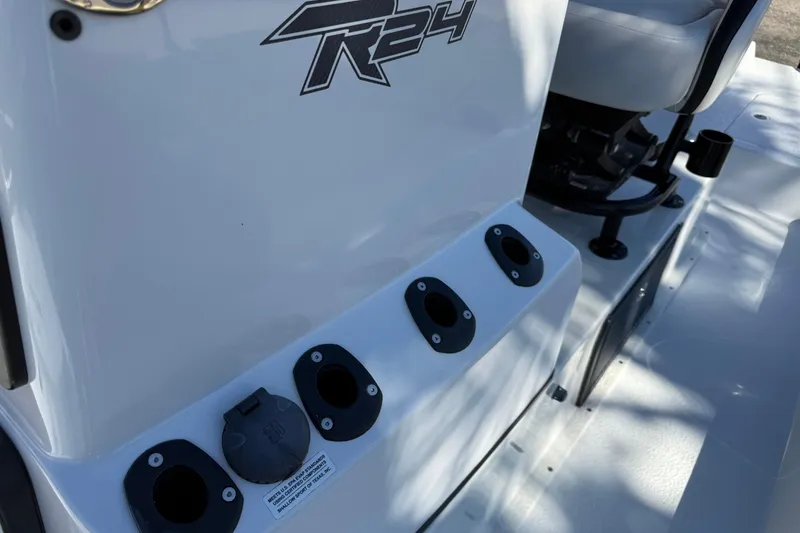 Slide: The Image of Steering wheel and controls of 2024 SCB R24 boat, featuring bow adjustment buttons. - 34
