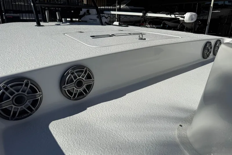 Slide: The Image of 2024 SCB R24 boat seats with Suzuki 350 engine in a parking lot. - 38