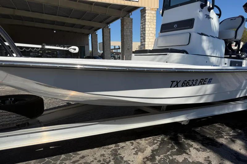 Slide: The Image of Two people proudly display a large fish on a 2024 SCB R24 boat. - 4