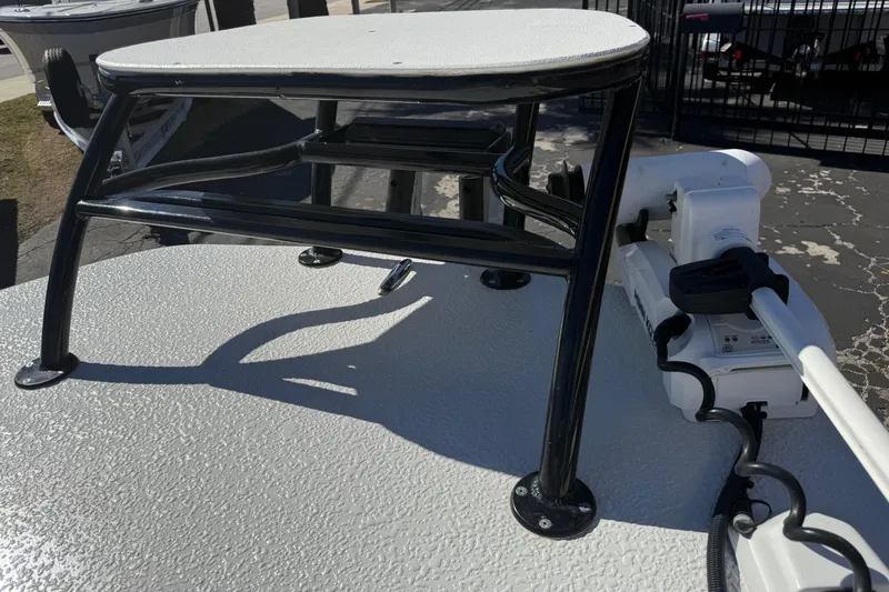 Slide: The Image of 2024 SCB R24 boat with console and seating, parked near a road. - 41