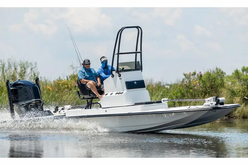 Slide: The Image of 2024 SCB R24 boat on trailer, featuring Suzuki outboard motor, parked outdoors. - 52