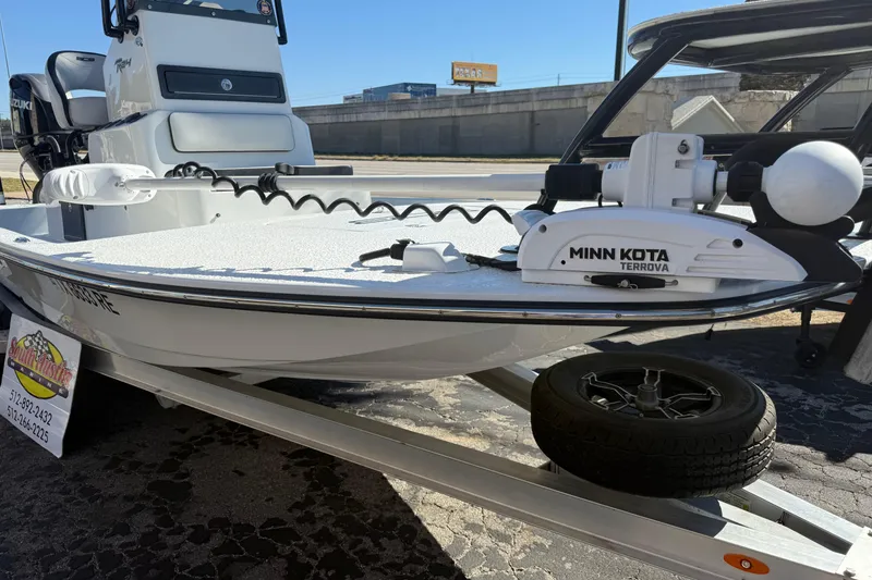 Slide: The Image of 2024 SCB R24 boat with Suzuki engine on trailer, parked outdoors. - 6