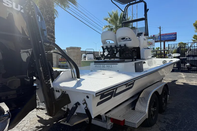 Slide: The Image of 2024 SCB R24 boat with Suzuki 350 engine, parked outdoors at a dealership. - 7