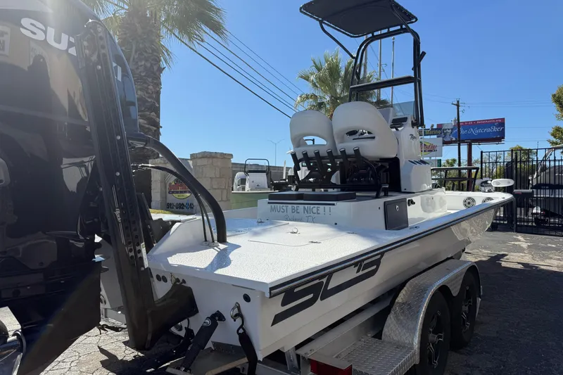 Slide: The Image of 2024 SCB R24 boat with Suzuki engine at dealership, featuring dual seats and trailer. - 8