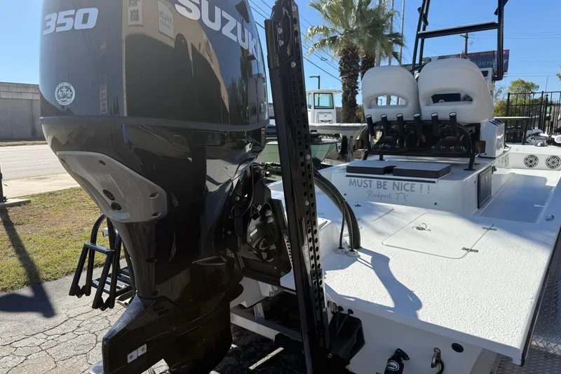 Slide: The Image of 2024 SCB R24 boat with Suzuki engine parked outside dealership. - 9