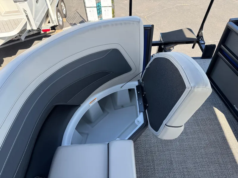 Slide: The Image of Barletta Cabrio 24U 2026 boat interior with open storage compartment and cushioned seating. - 15