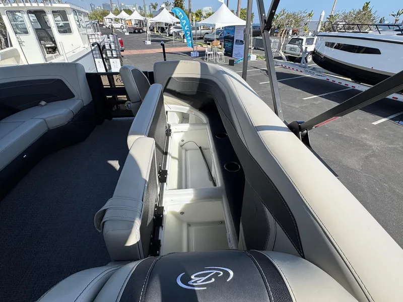 Slide: The Image of 2026 Barletta Cabrio 24U boat interior with open storage compartments and seating. - 20