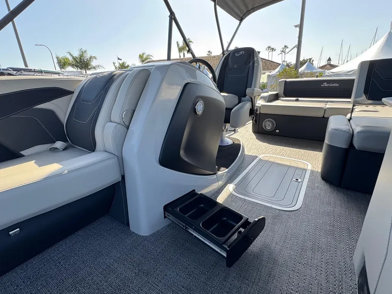 Slide: The Image of 2026 Barletta Cabrio 24U boat interior with modern seating and steering console. - 21