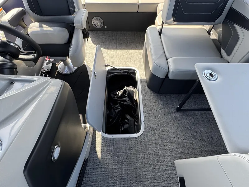 Slide: The Image of 2026 Barletta Cabrio 24U boat interior with open storage compartment and seating. - 23