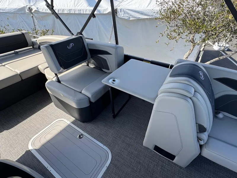 Slide: The Image of 2026 Barletta Cabrio 24U boat interior with gray seating and table. - 24