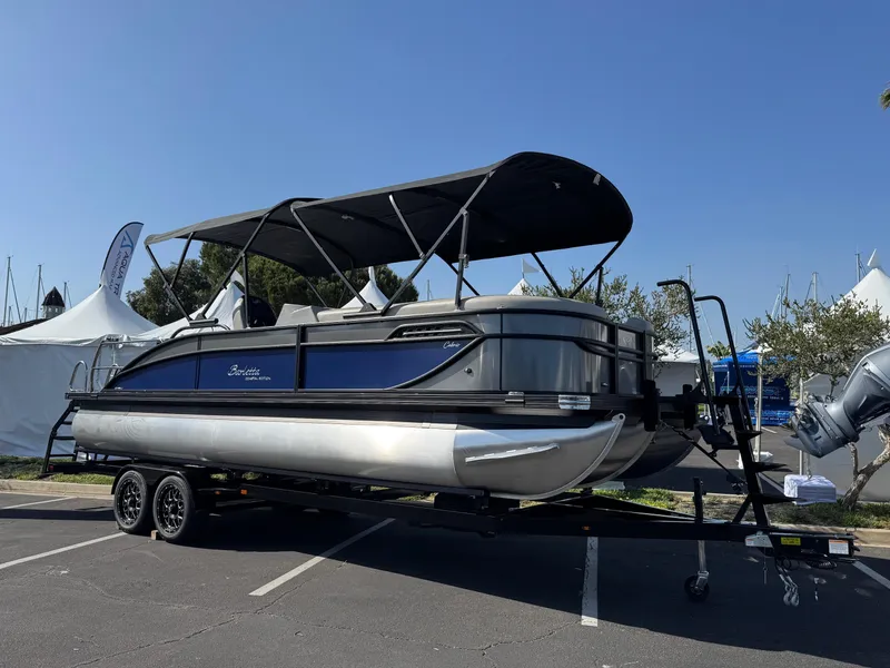 Slide: The Image of 2026 Barletta Cabrio 24U pontoon boat on trailer, displayed outdoors under clear sky. - 3