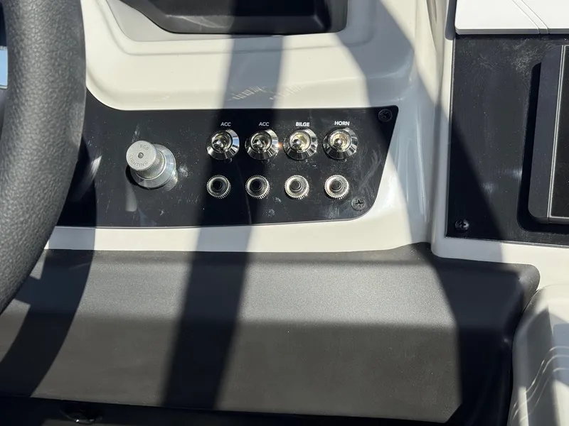 Slide: The Image of Control panel of 2026 Barletta Cabrio 24U boat with switches and RGB lighting knob. - 34